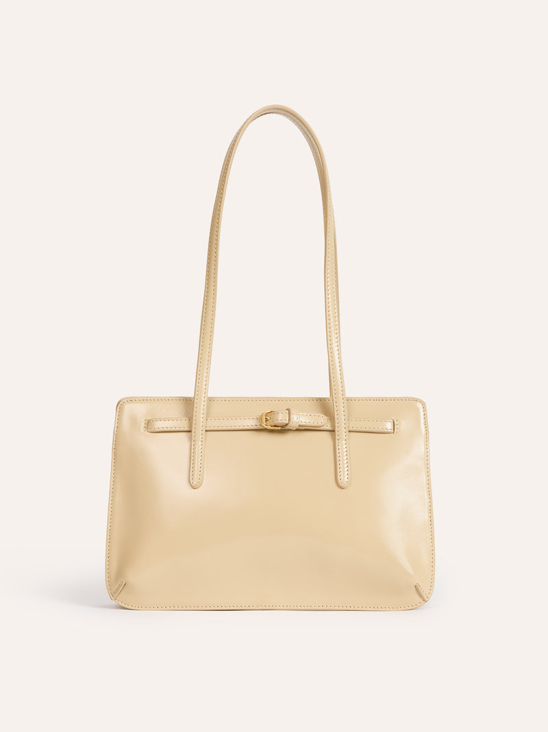 FIANCE champagne glazed leather handbag worn on a model by Rouje
