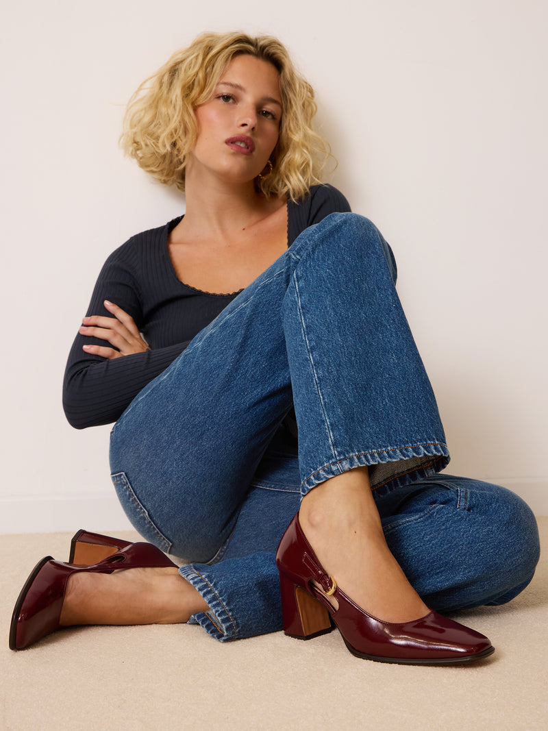 BRERA burgundy patent leather openwork pumps worn on a model by Rouje