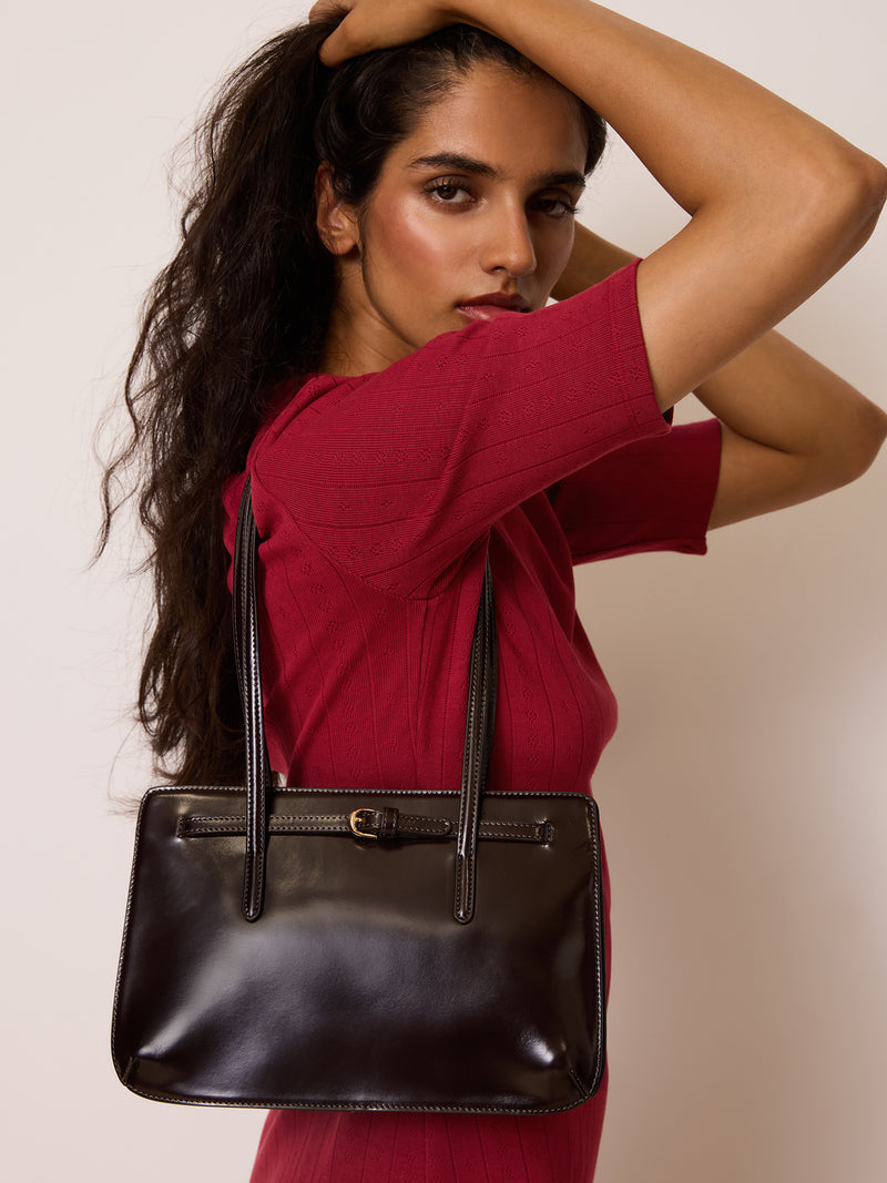FIANCE cafe brown glazed leather handbag worn on a model by Rouje